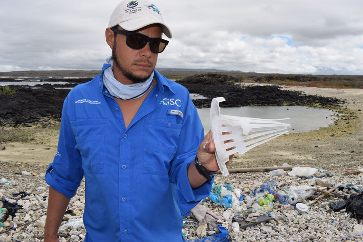 JP Muñoz with plastic waste on a Galapagos beach