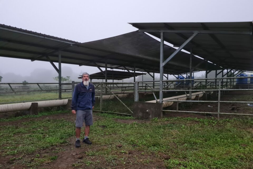 Claudio Cruz standing next to his cow shed on Floreana